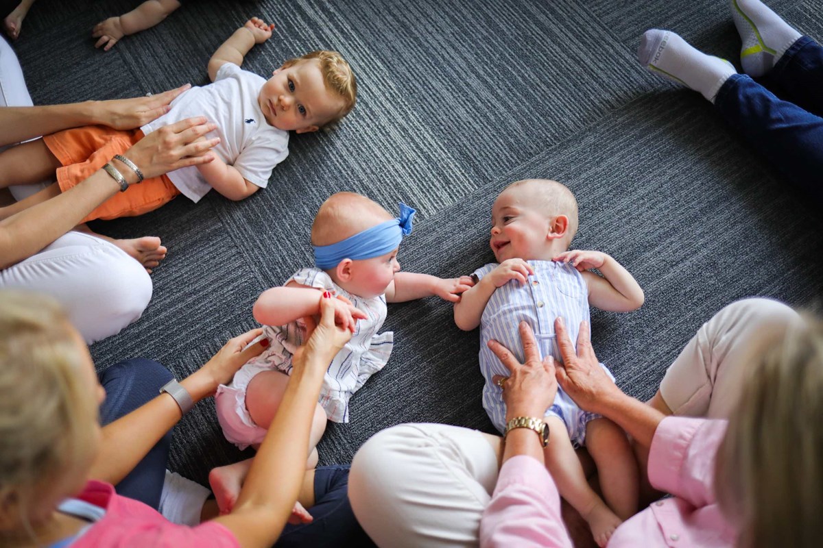 Babies and their parents participating in a Kindermusik foundations level activity.