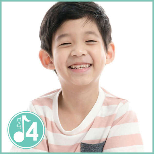 Alt Text: 4-year-old boy smiles during a Kindermusik Level 4 class.