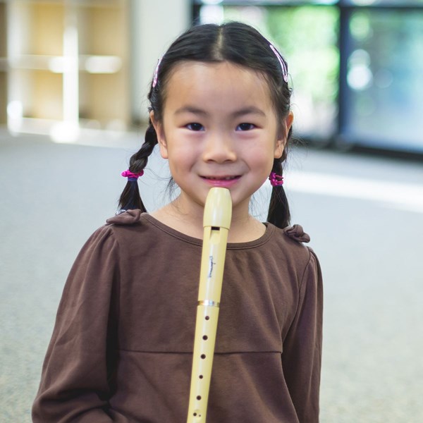 Kindergartner plays the recorder during music classes for 5-7-year-olds.